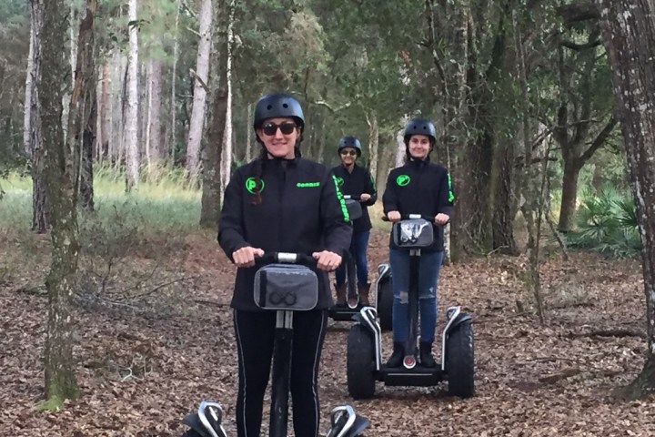 a person riding a motorcycle in a forest