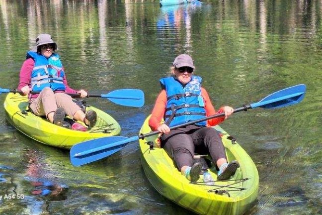 a group of people rowing a boat in the water