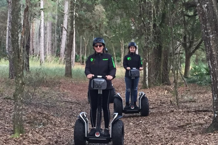 a person riding a bike down a dirt road