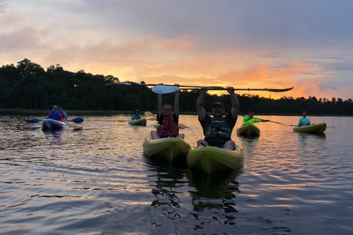 a group of people in a boat on a body of water
