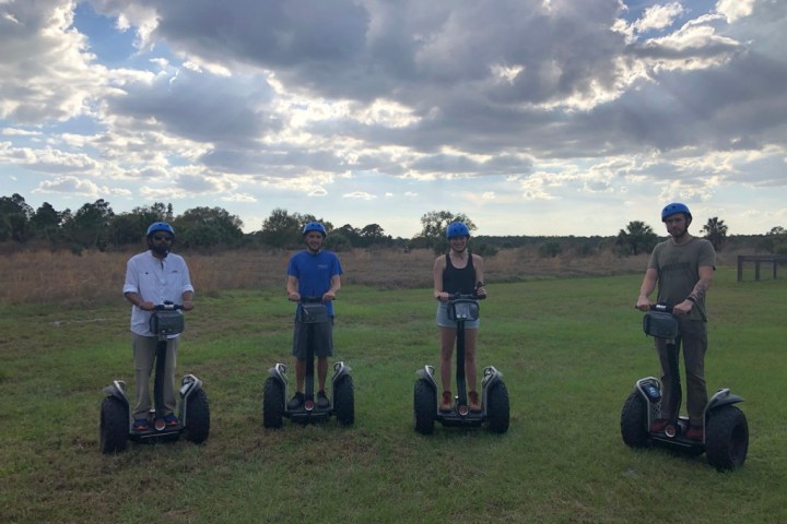 a group of people sitting around a baseball field