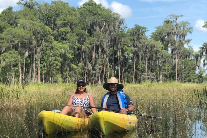 a man riding on the back of a boat in a body of water