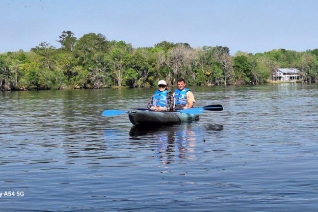 a man rowing a boat in a body of water