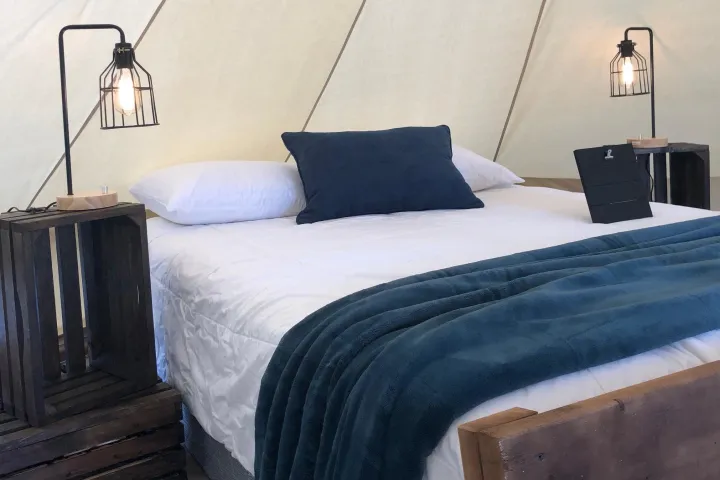 a bedroom with a bed and desk in a room